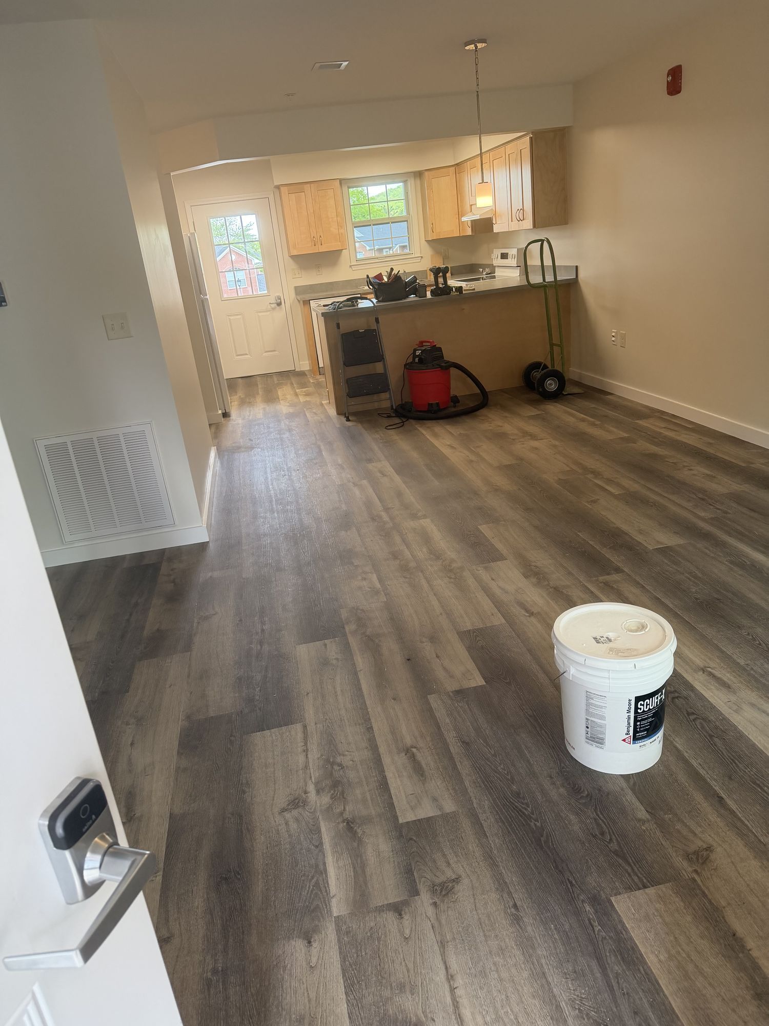 Apartment living area and kitchen with plank flooring
